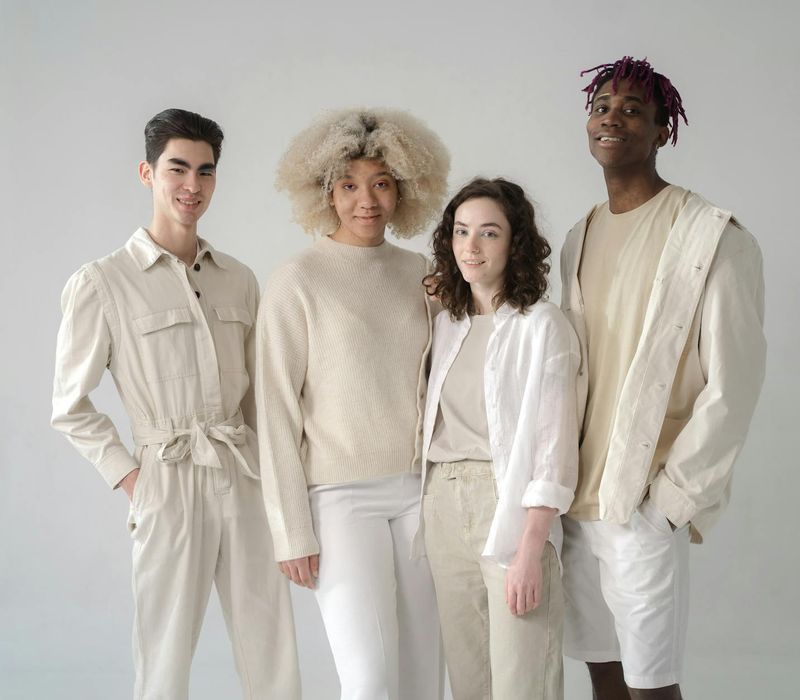 A group of diverse people smiling and moving freely in a bright, spacious studio.